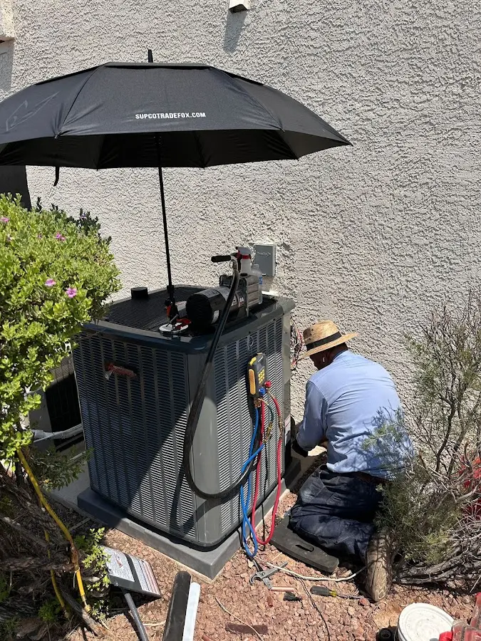 HVAC technician performing outdoor AC maintenance in St. Johns